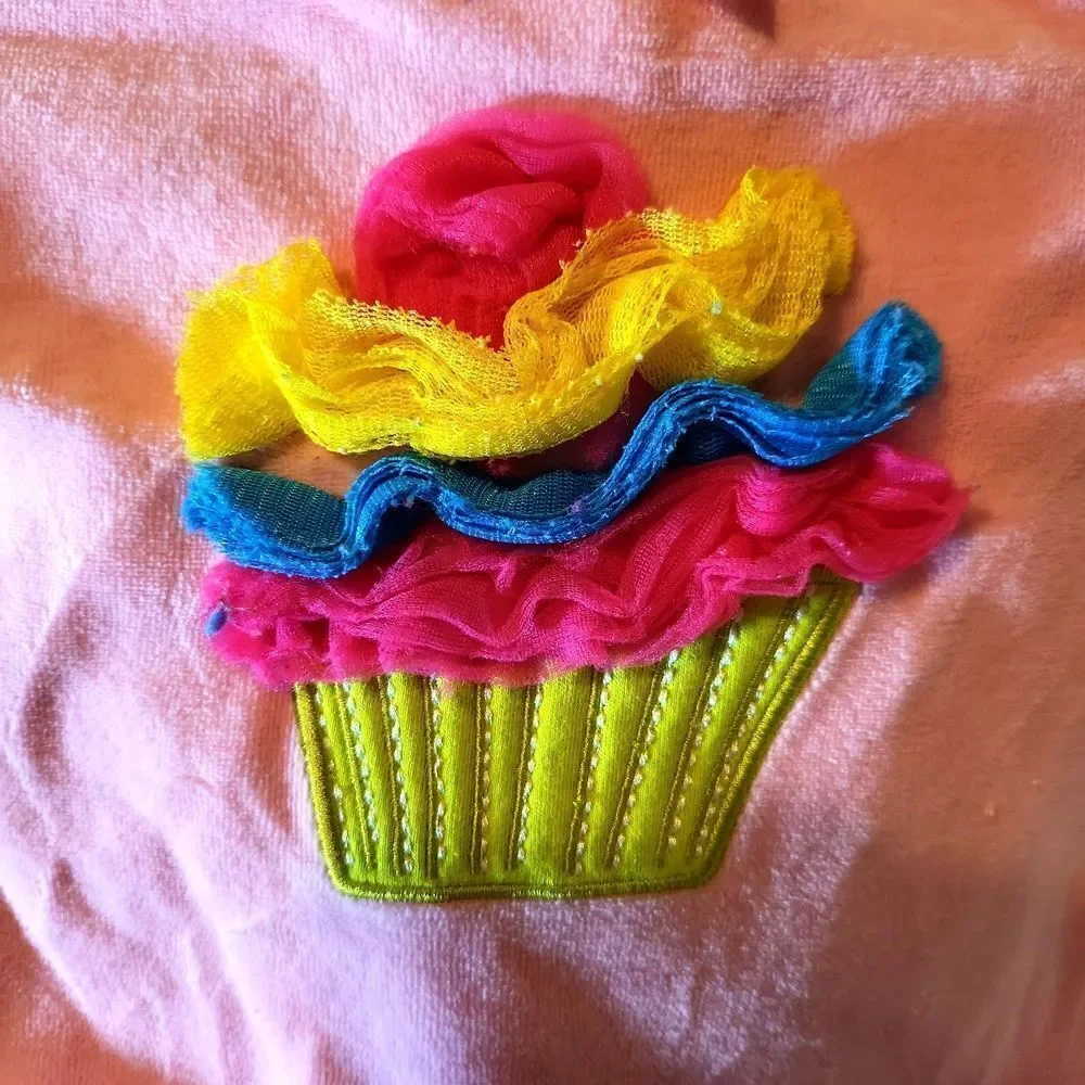 Brand new, pink one piece, velour so soft wit a cute cupcake and ruffled icing
